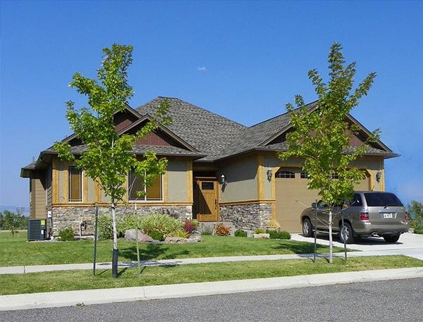 Photo of a one story home with a silver SUV in the driveway.