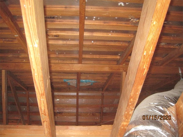 Photo of an attic in a home of a home in an asbesotos removal project overseen by Precision Environmental Services.