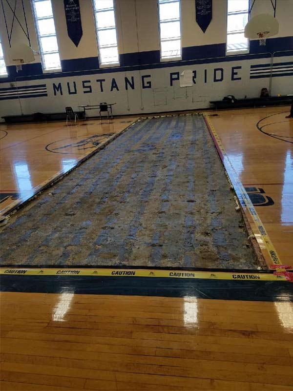 Photo of a section of a gym floor removed in an asbesotos inspection project performed by Precision Environmental Services.