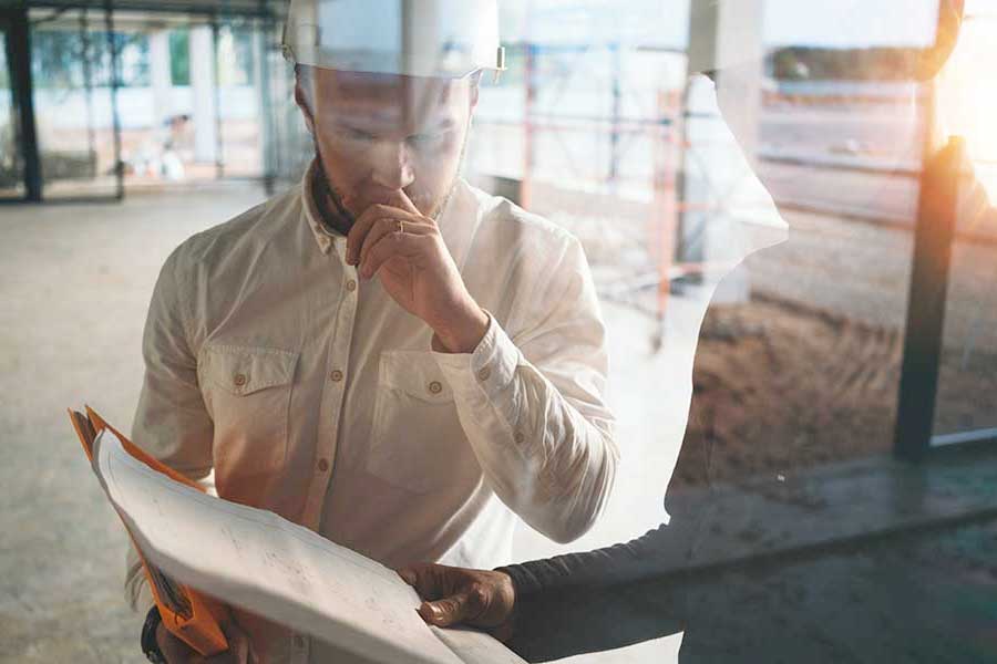 Photo of an inspector speaking with a co-worker in a building